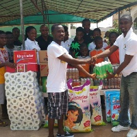 Friends of Aberga presenting items to the Teshie Orphanage