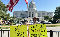 A demonstrator outside Missouri’s State Capitol supports a redistricting referendum