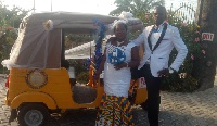 Mr. and Mrs. Dakudzi standing by the well decorated tricycle