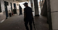 Armed member of the Nigeria Security and Civil Defence Corps (NSCDC) patrols a train station