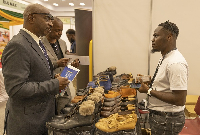 Bright Aferi, co-founder of Hillbill interacting with clients at the Ghana expo in Kenya