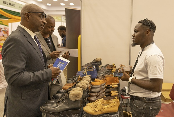 Bright Aferi, co-founder of Hillbill interacting with clients at the Ghana expo in Kenya