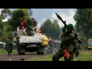 A Conglese government soldier mans a checkpoint at the front line
