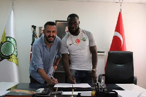 Elvis Manu with a club official