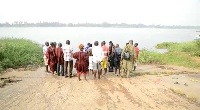 The traditional authorities gathered at the bank of the river to summon the gods