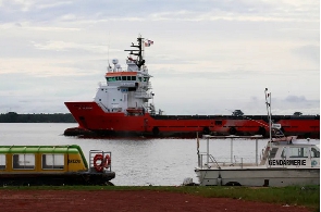 A ship passes near the port of Abidjan, April 23, 2013 [Thierry Gouegnon/Reuters]