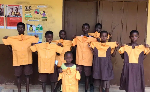 School children are seen holding school uniforms
