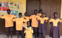 School children are seen holding school uniforms
