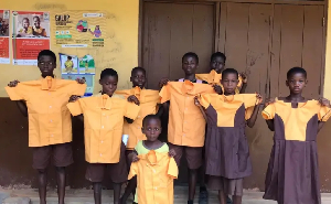 School children are seen holding school uniforms