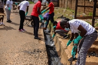 Employees of Vivo Energy Ghana and United Way Ghana distilling gutters during the clean-up exercise