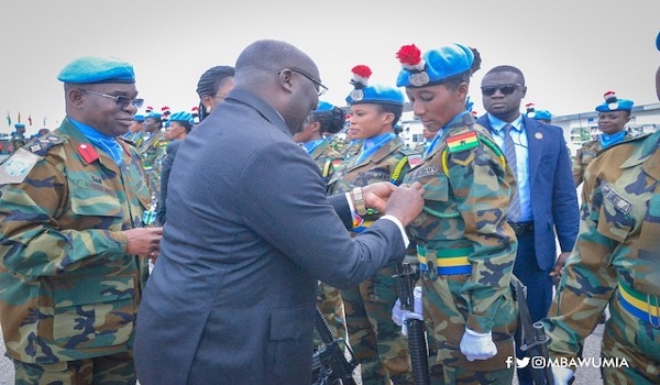 Dr. Bawumia pinning medals on troops at a colourful ceremony