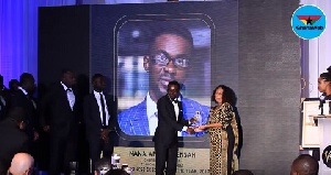 Nana Appiah Mensah, Chief executive officer (C.E.O) of Zylofon Media (L) receiving his award