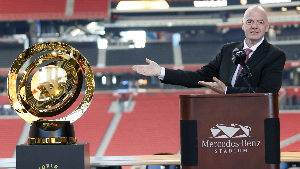 The FIFA Club World Cup trophy (L) and FIFA President Gianni Infantino (R)