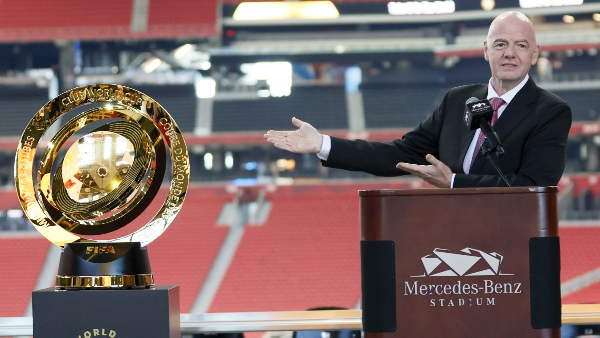 The FIFA Club World Cup trophy (L) and FIFA President Gianni Infantino (R)