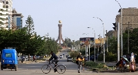 A general view shows motorists and a biker near the Tigray Martyrs monument in Mekele