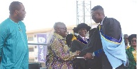 President Akufo-Addo congratulating one of the best graduating students