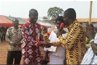 The DCE,William Bediako Asante (right), presenting the best farmer with his award