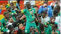 Senegal's Sadio Mane holds the trophy aloft as he celebrates with teammates after winning the AFCON