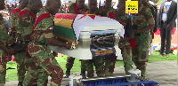 Zimbabwean soldiers salute as caskets of Wicknell Chivayo and his wife arrive