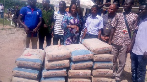 Lawyer Charity Akua Oforiwaa Dwommoh (3rd Left), presenting the building materials