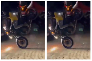 A KNUST student falls after his motorcycle overturns during an SRC Week celebration stunt