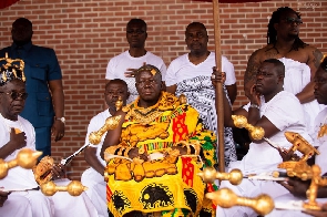 Otumfuo Osei Tutu II dressed in his royal regalia, seated in state