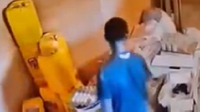 A screenshot from the video capturing the young man picking up items from the shop