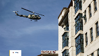 A Kenya Air Force helicopter flies over a hotel complex in Nairobi, Kenya Tuesday, Jan. 15, 2019
