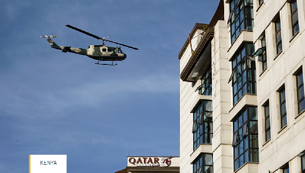 A Kenya Air Force helicopter flies over a hotel complex in Nairobi, Kenya Tuesday, Jan. 15, 2019