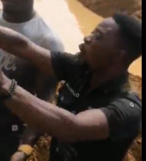 A man engaged in a scuffle with illegal miners