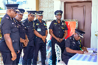 Christian Tetteh Yohuno signing the book of condolence