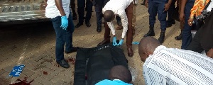 Police conveying bodies of the victims from the scene of the crime
