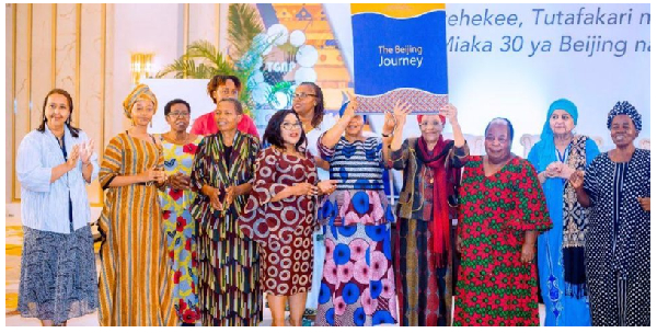 Women leaders take a group photo after a forum, marking  30 years of Beijing conference