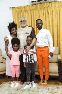 Okyeame Kwame and family in a shot with Rawlings