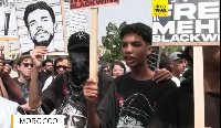 People take part in a youth-led protest against corruption and calling for education and healthcare