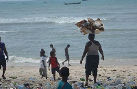 Woman dumps refuse at the coast.    Photo: Joojo Cobbinah