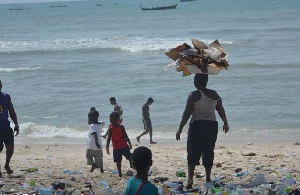 Woman dumps refuse at the coast.    Photo: Joojo Cobbinah