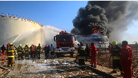 Firefighters work to contain a fire at the Zawiya oil refinery following a drone strike in Zawiya