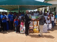 Official of the Orphanage recieves the items from Rev Isaac Mensah
