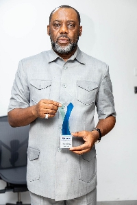 Dr, Mathew Opoku Prempeh displays his award