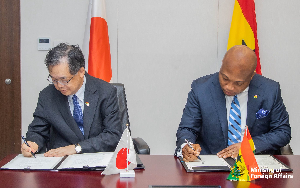 Hiroshi Yoshimoto with Samuel Okudzeto Ablakwa during the signing of the agreement