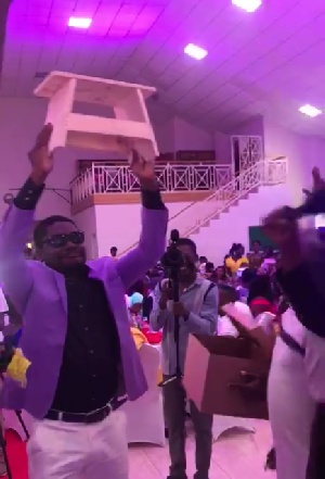The groom with the kitchen stool presented by his friends