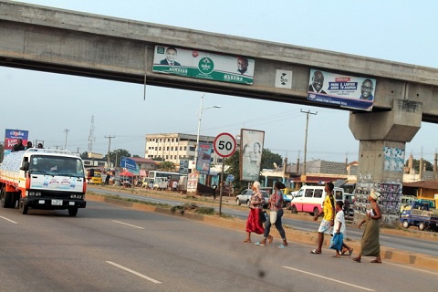 File photo: Some pedestrians crossing the highway before the overhead footbridges were completed