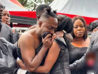 Choirmaster getting consoled by one of his daughters