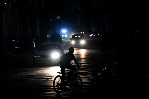 A man rides his bicycle down a street during a blackout in Havana