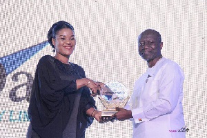 Mrs Abigail Mckorley receiving the Ghana Club 100, 36th prize from Finance Minister, Ken Ofori Atta