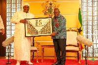 President Akufo-Addo presenting a gift to President Adama Barrow