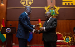 President Akufo-Addo presenting the charter to the Tobinco boss