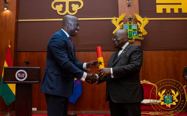 President Akufo-Addo presenting the charter to the Tobinco boss