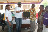 Mr. Enang (second from left), presenting the items to Dr. Dadebo